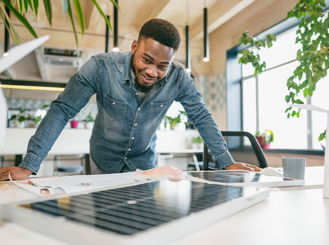 man looking at solar panel